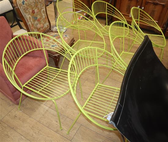 A set of seven green wirework tub chairs